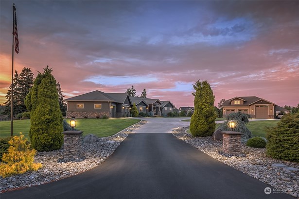 This magnificent custom estate has it all! A privately gated drive, generous manicured acreage, beautifully designed custom home, detached shop, and apartment - all in a prime, desirable area.