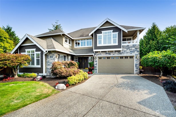 Spacious driveway and meticulous landscaping welcome you to this lovely home