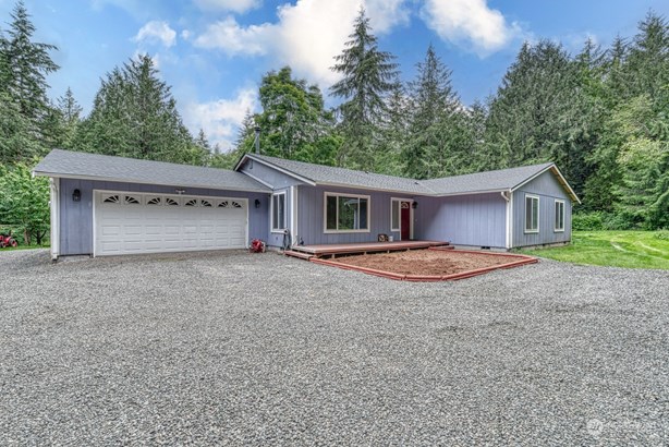 Fresh gravel just installed on driveway prior to coming on the market. To the right features more open space on the side of the house.