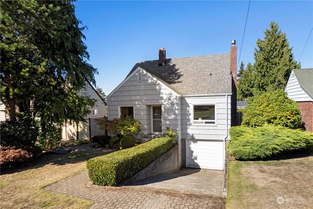 A view from the sidewalk. Note the attached garage at basement level.