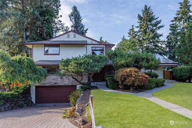 lovely front lawn and entry welcome you to this mid century gem with fantastic layout