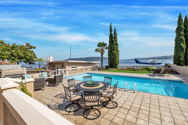 Lakefront with an in-ground pool and hot tub. Boat house with spiral staircase leading to the helipad.