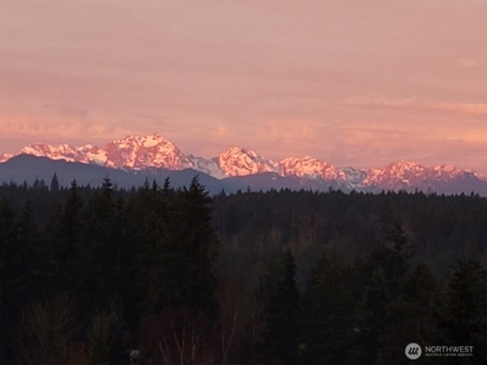 Wake up to the glow of the Olympic Mountains