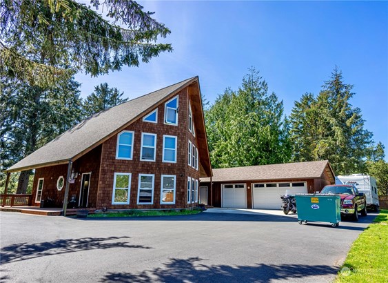 The feel of the mountains at this beach home with 3 car garage, RV storage and paved parking.