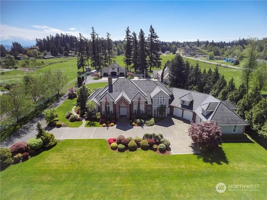 Experience the unmatched beauty of this gorgeous Edgewood Estate. Featuring not only the exquisite residence but also a heated 3-car shop and a charming cedar-lined barn/storage building nestled behind.