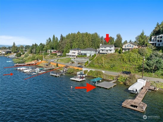 The large gray dock w/green cover over boat lift belongs to this house PLUS private community beach/cabana/marina