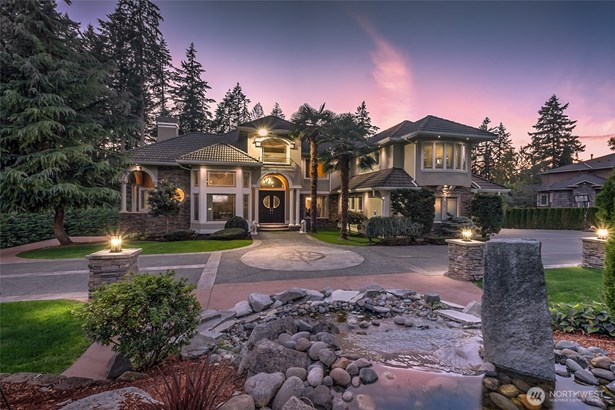 Stunning palatial estate, set on 2.37 acres, featuring elegant architectural details, lush landscaping, and a serene water feature for the perfect blend of elegance and serenity.