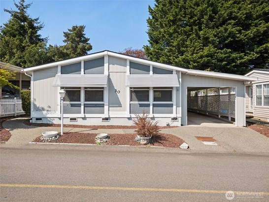 Front view of property, I LOVE the low-maintenance yard and the extra deep carport!