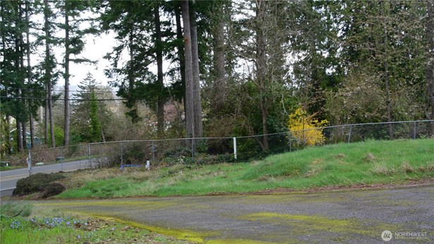 Lot E extends across the Driveway. Owner to access property through a differant access