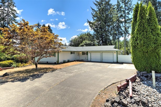 What a beautiful home with nice big paved driveway!