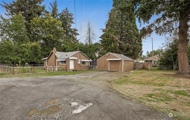 A charming downtown Puyallup house and shop nestled on a spacious private lot, offering a perfect blend of comfort and functionality with ample room for work, living, parking, and outdoor enjoyment.