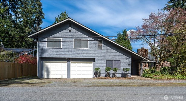 Fully fenced home with 2-car attached garage and 1-car detached garage.