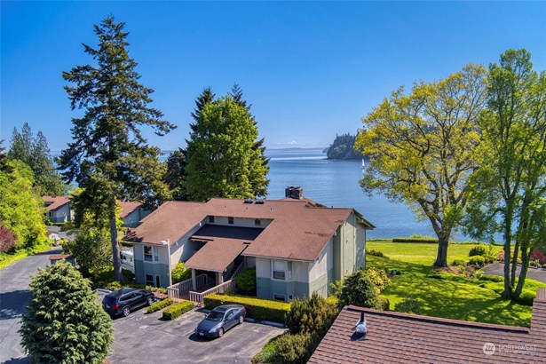 Unit in bottom left corner of this building.  Open grass to the water.