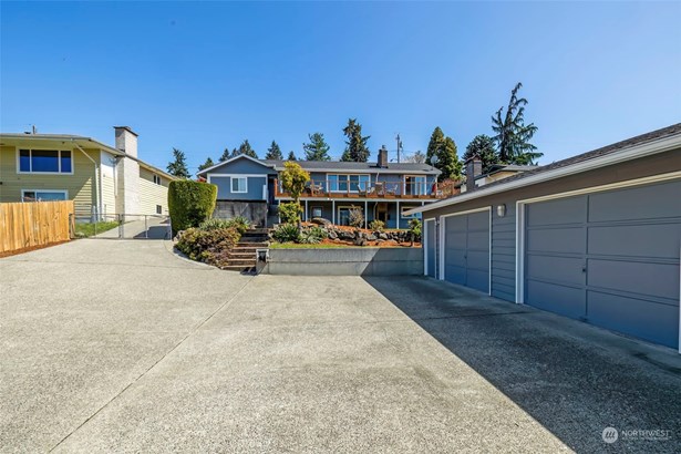 Welcome Home! Beautifully landscaped yard with plenty of parking for your guests & recreational vehicles. Smooth transition from Driveway to garage for Custom Car enthusiasts!