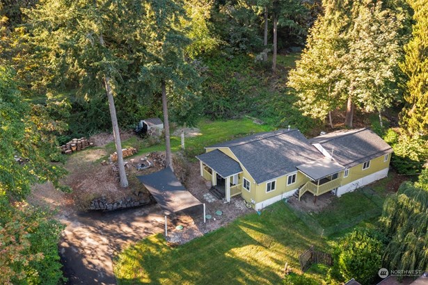 This cute country home is nestled on a peaceful acre with woods to explore.