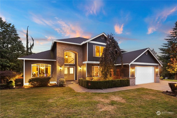 Front of home with mature trees