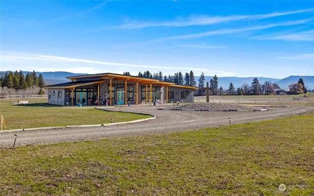 A breathtaking custom home crafted with timber and steel beams, nestled on 7.8 acres.