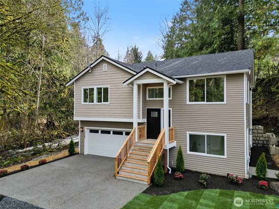Beautifully landscaped home with a lovely creek adjacent to property.