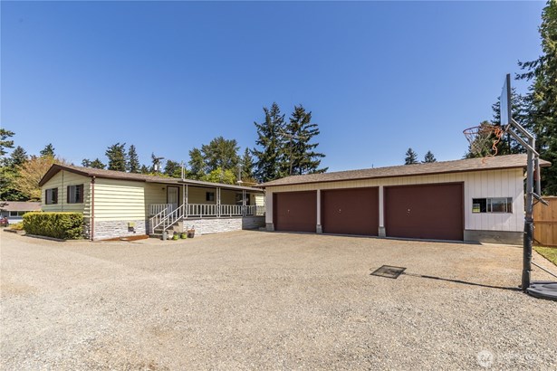 Well-maintained double-wide with a 3-car detached garage