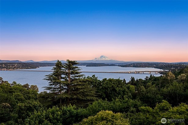 Protected panoramic views from all levels of this custom two-story with basement home