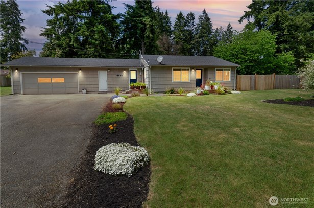 Twilight charm and warm curb appeal This cozy home glows with inviting evening light, beautifully framed by fresh landscaping and a peaceful, spacious yard. A perfect place to come home to.