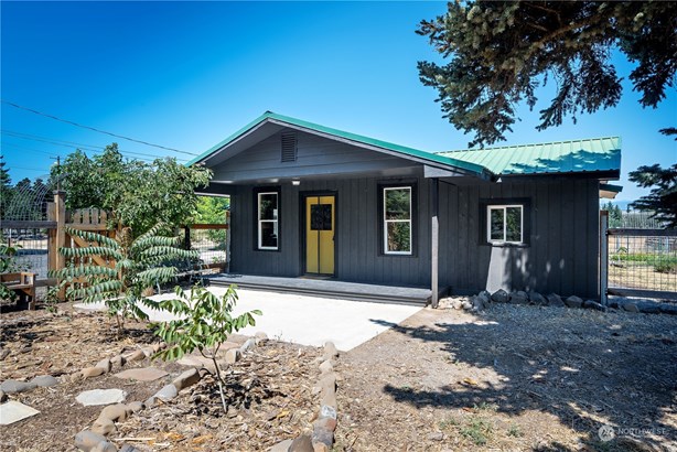 Enjoy the convenience of a covered porch with easy access to the fenced yard.