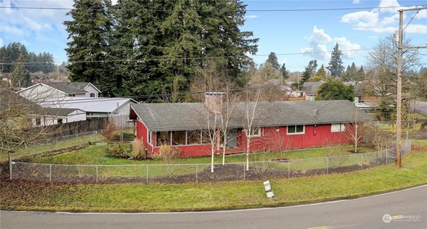 Drone shot of the front of property, TWO levels of living on a huge corner lot, fully fenced!