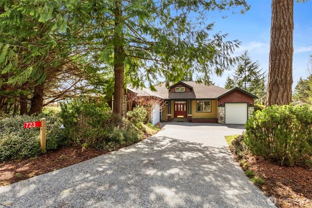 Beautifully sited among the trees, this quintessential northwest contemporary on a roomy 1/2 acre lot, has room for everyone and every activity, with a partial water view and close proximity to all Port Ludlow amenities.