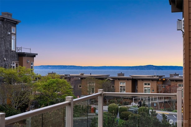 Welcome to this coveted corner unit at Point Edwards where you can enjoy the iconic PNW sunsets from your private patio.