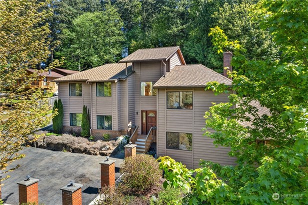 Prepare to fall in love as soon as you arrive  at this gorgeous home on acreage! Custom built with architectural interest, it is  surrounded by tranquility on over an acre.  The home boasts a durable 50-year roof to   provide you with long-lasting protection and  peace of mind.