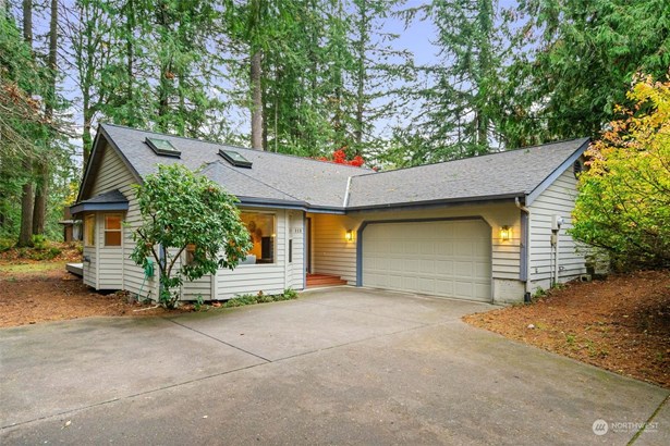 View from driveway. Single level home w/ 2 car garage.