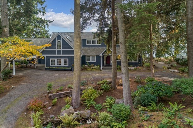 This spectacular waterfront estate has breathtaking views of the Puget Sound, the Cascade Mountain Range, Mt. Rainier, and the Seatle Skyline. It is situated on 1.8 acres, and includes an additional .85 acres of deeded tidelands of Puget Sound shoreline. This is a double lot with 150 feet of high-bank waterfront frontage, and with its R-2 zoning it can be subdivided to allow at least one additional building lot for future development (buyer to verify). The private stairs down to the secluded sandy beach will give you the opportunity to take strolls along the beach at low tide and enjoy the abundant sea life. This wonderful property includes a separate 717 sq. foot cottage that has been recently updated and has an amazing covered view deck. This property has a two-car garage, a two-car carport, professional landscaping with several water features, and an adorable playhouse. 150 feet of accessible bulkheaded beach + 1.8 acres of land with a separate guest cottage = a rare find indeed.