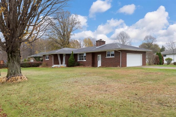 Brick Ranch with 2 car sideload garage.