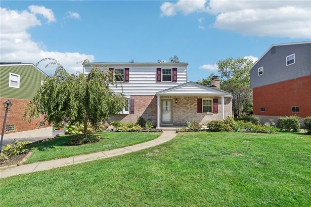 Level entry, mature landscaping, & a covered front