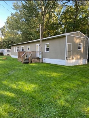 The mobile home is on a block foundation with a bu