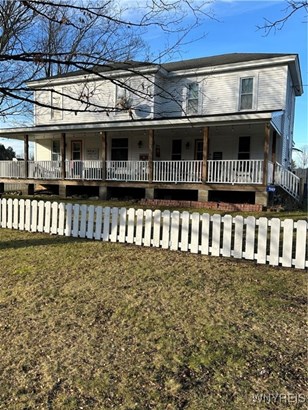 Front porch is sheltered from rain and sun by the