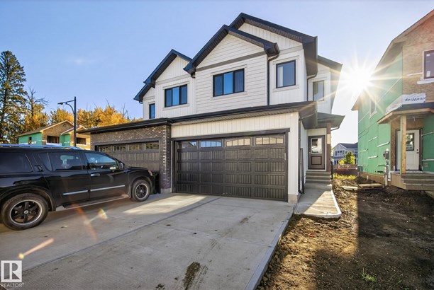 View of front of house featuring board and batten siding and concrete driveway