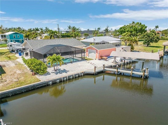 Aerial of home, pool, dock, and lift, with detached garage!