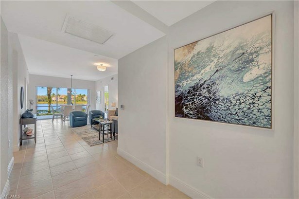 Foyer with a water view and light tile floors