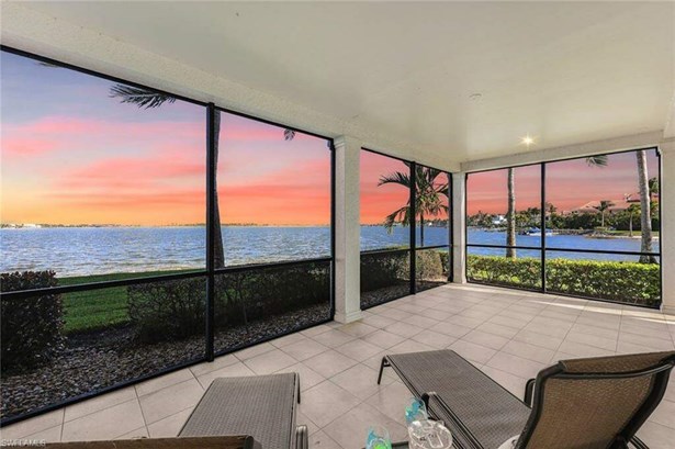 Sunroom / solarium featuring a water view